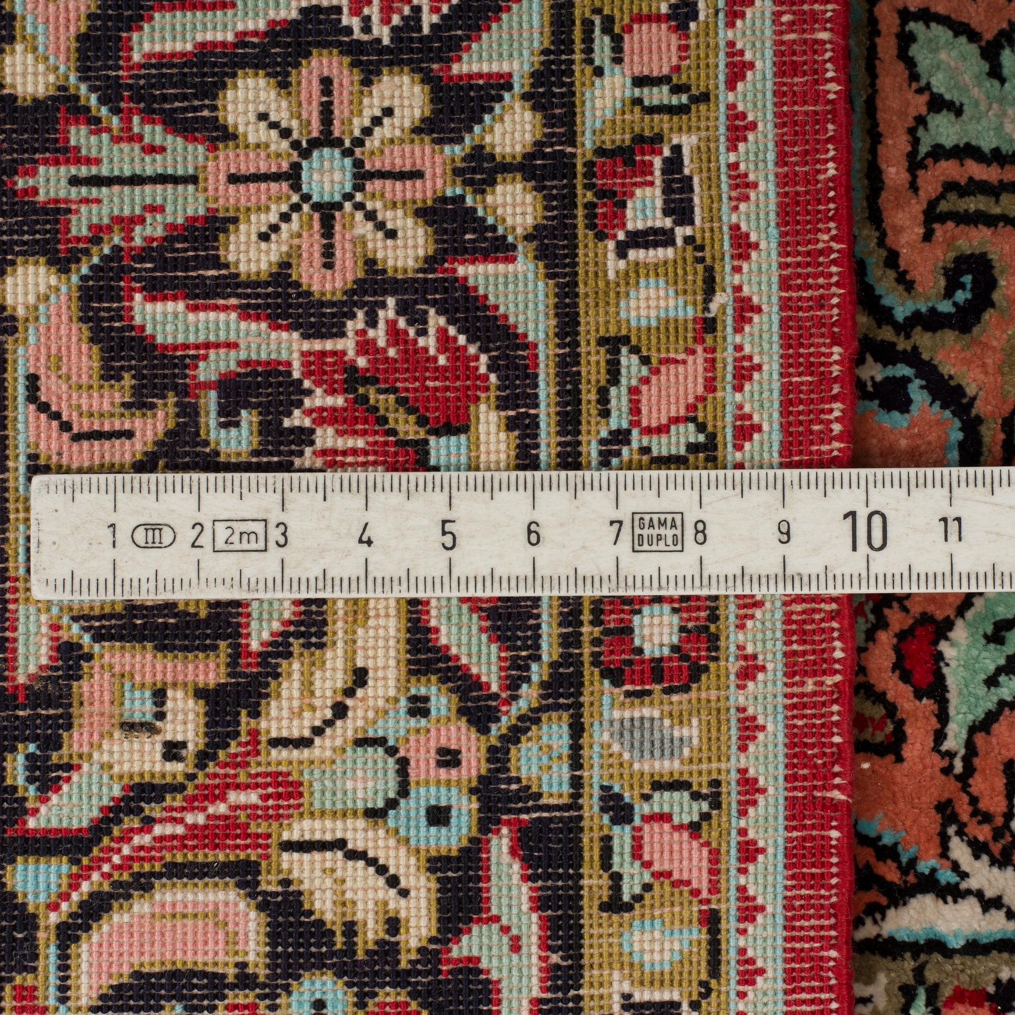 A silk Qum rug, around 114 x 80 cm.