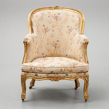 A Louis XV-style bergère armchair with stool, second half of the 19th century.