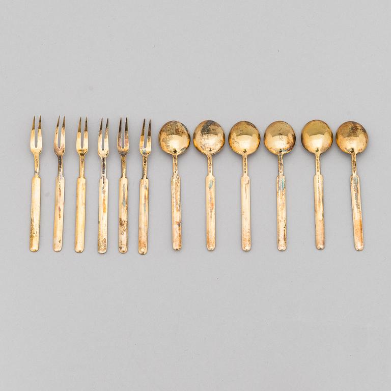 A 12-piece set of 1950s two-tine forks and espresso spoons in gilt silver and enamel, Tillander, Helsinki 1951-55.