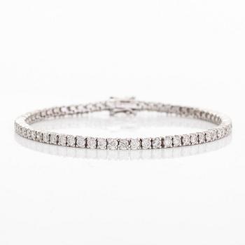 An 18K white gold tennis bracelet, with brilliant-cut diamonds totalling approximately 3.84 ct according to engraving.