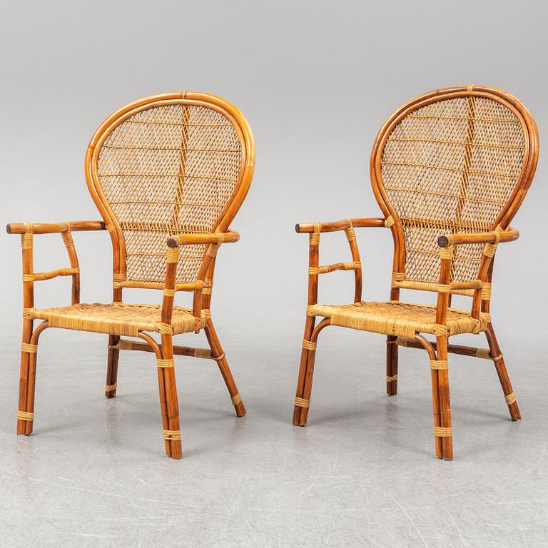 A pair of rattan chairs.