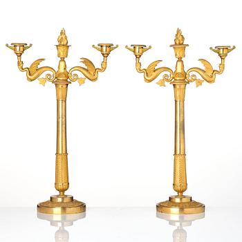 A pair of ormolu three-branch Empire candelabra, early 19th century.