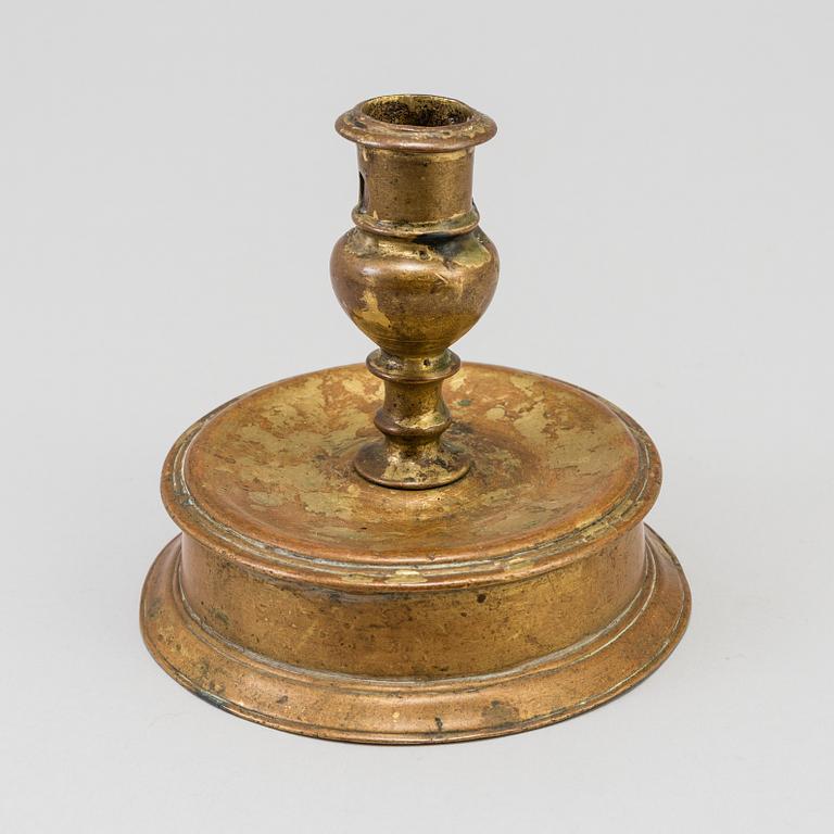 A 17th century bronze candlestick.