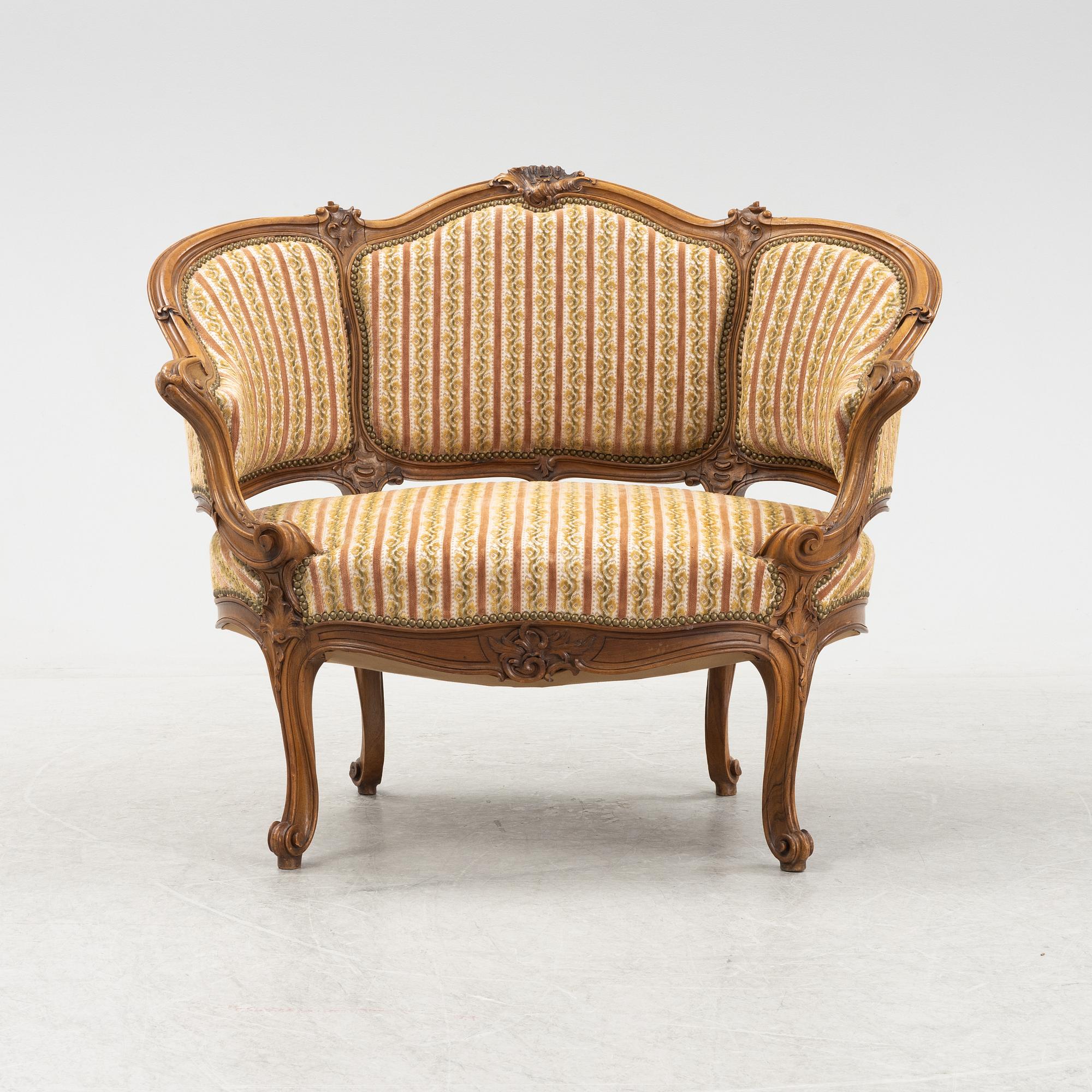 A Louis XV style marquise chair, around the year 1900.