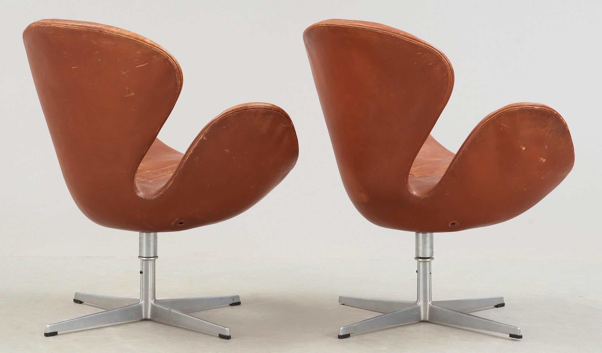 A pair of Arne Jacobsen brown leather 'Swan' chairs, Fritz Hansen, Denmark 1972.