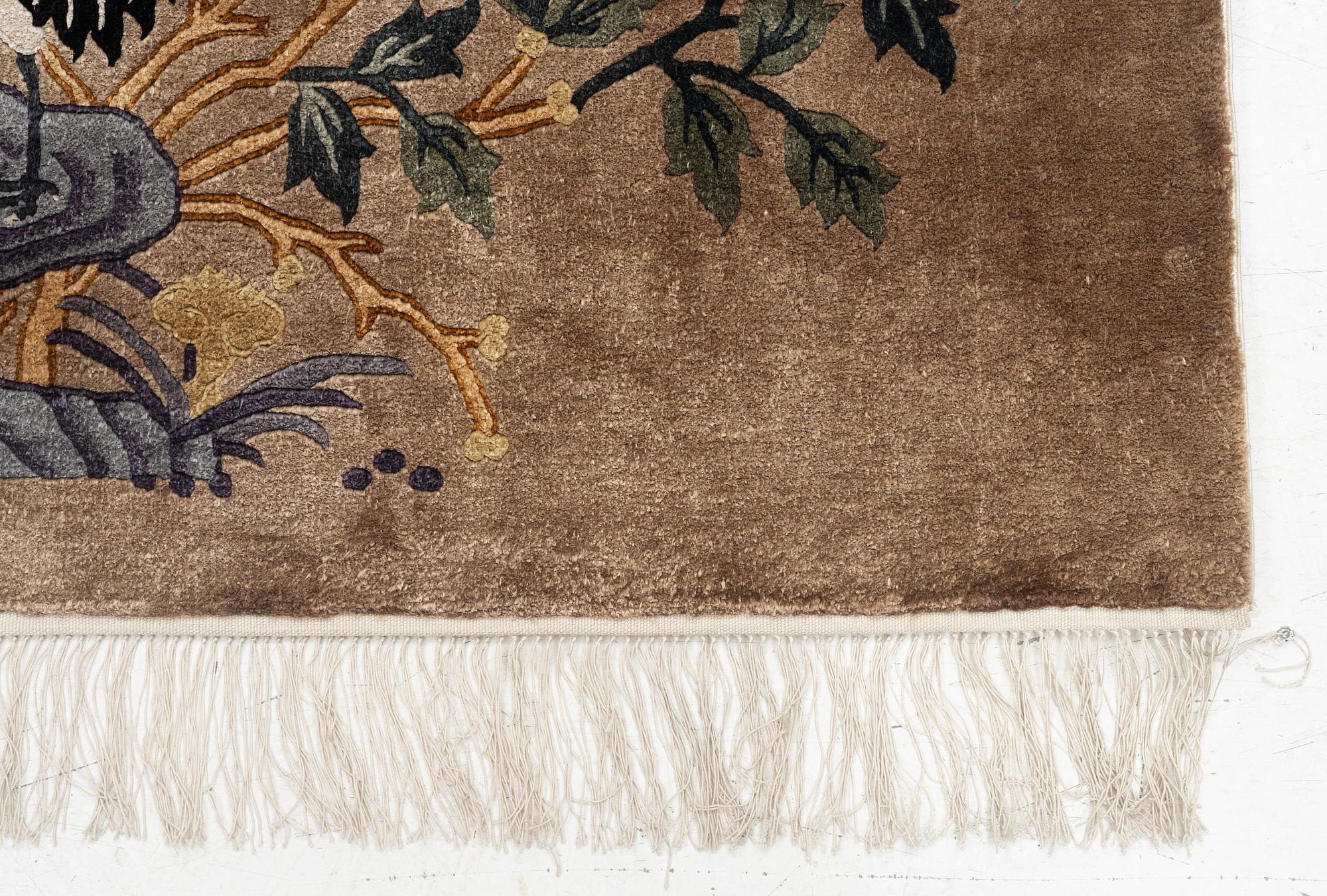 A silke figural rug, China, later part of the 20th century, ca. 92 x 170 cm.