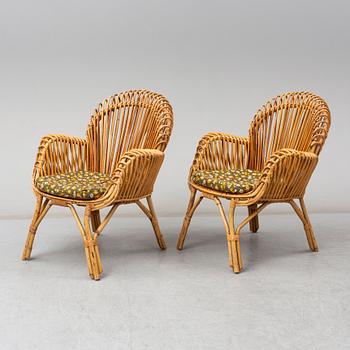 A pair of rattan armchairs, Emilio Paoli, via Vigna Nuova, 8, Firenze, Italy, second half of the 20th century. Signed.