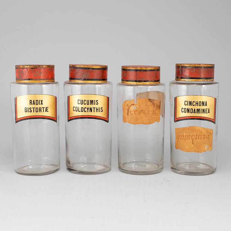 Four glas apothecary jars with metal lids, early 20th century.