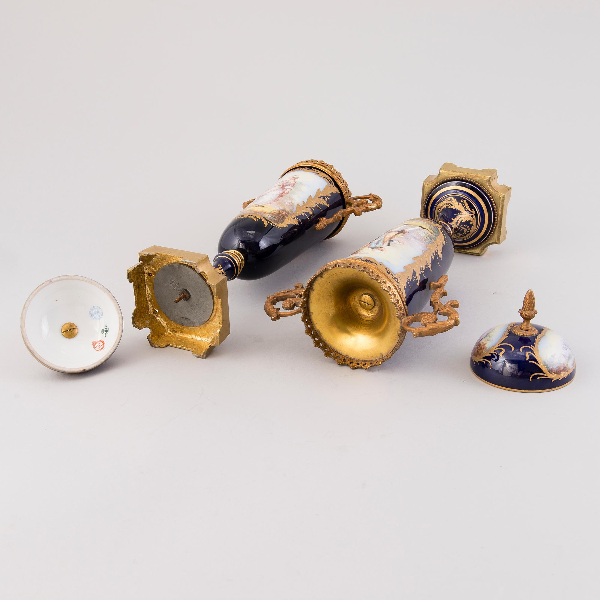 Pair of Sevres Chateau des Tuileries porcelain lidded urns, mid-19th century.