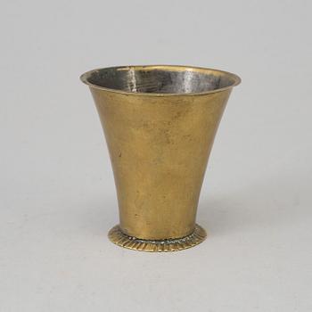 An 18th century brass beaker.