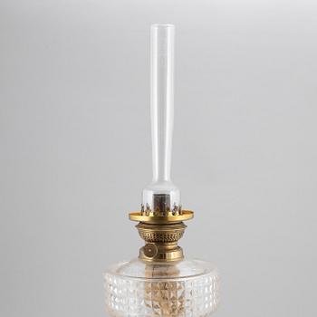 A brass oil lamp, ca 1900.