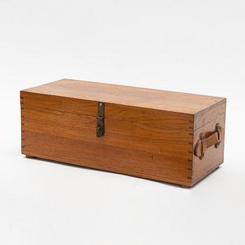 A teak box with 21 glass blottles, early 20th Century.