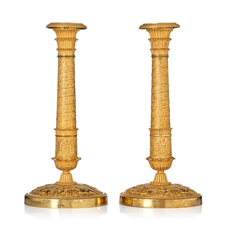 A pair of French Empire ormolu candlesticks, Paris, early 19th century.