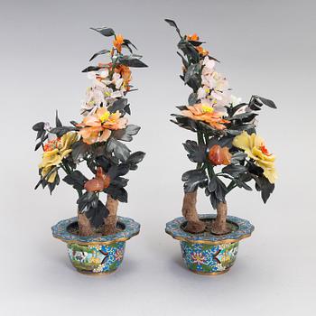 A pair of Chinese table decorations in various stones, enamelled pots. The latter half of the 20th century.