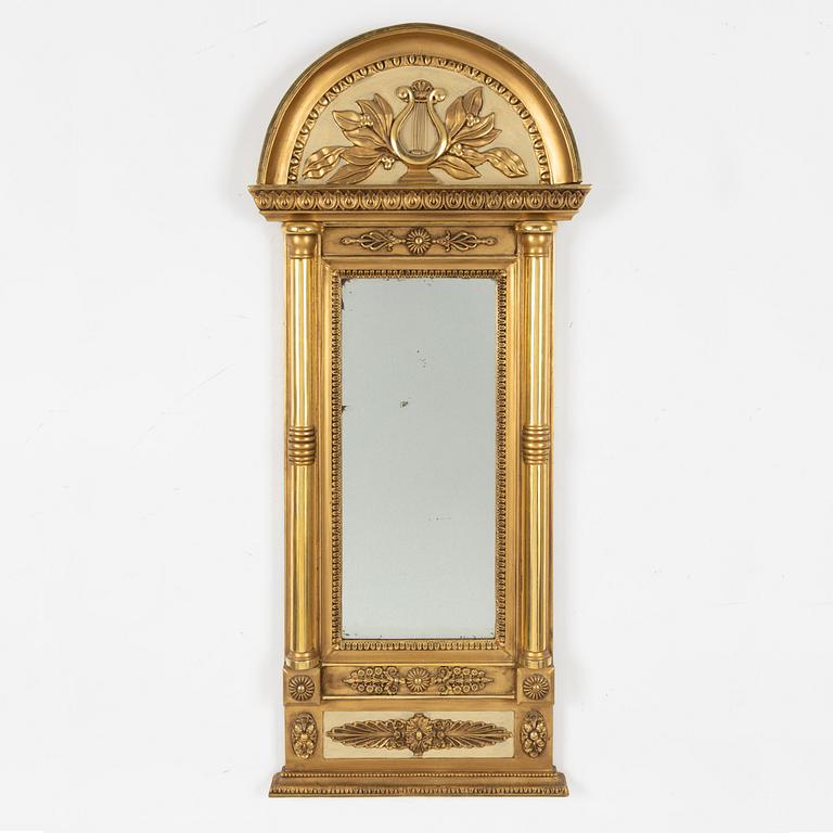 An Empire mirror, first half of the 19th century.