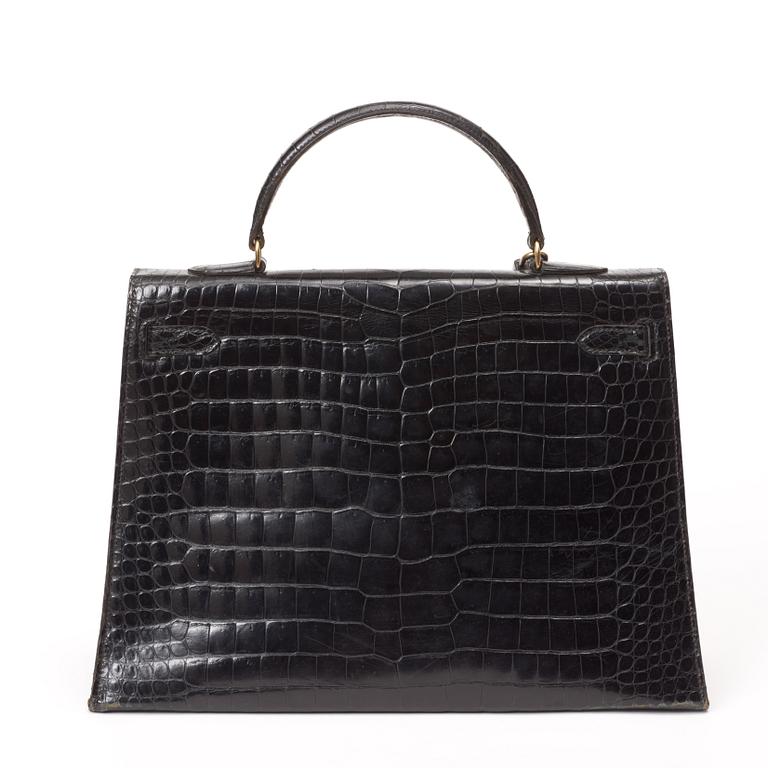 A 1960s/70s black crocodile leather handbag "Kelly" by Hermès.