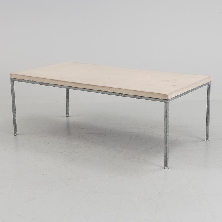 A modern sofa table with concrete top and steel legs.