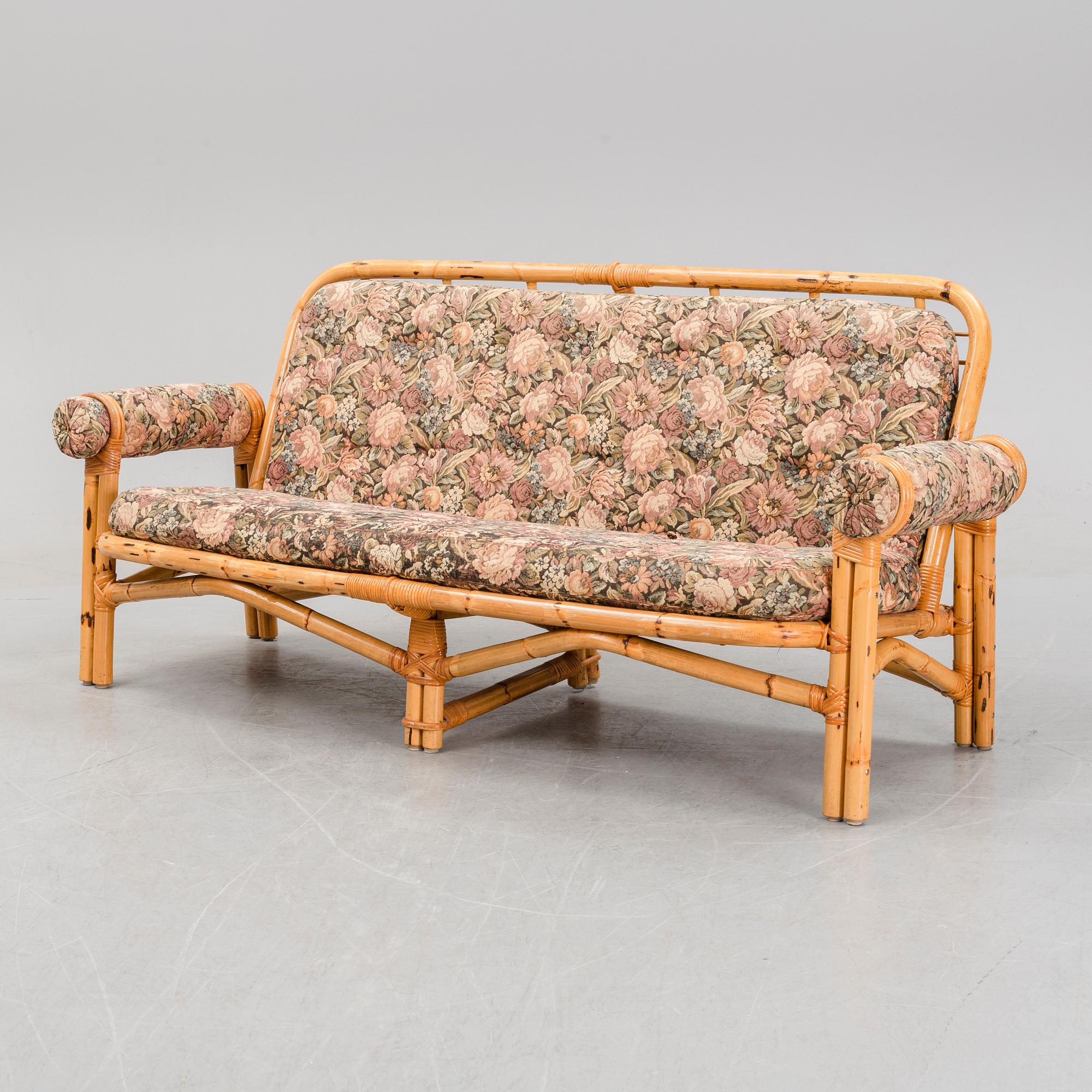 A set of two garden sofas, an armchair and a glass table, later part of the 20th Century.