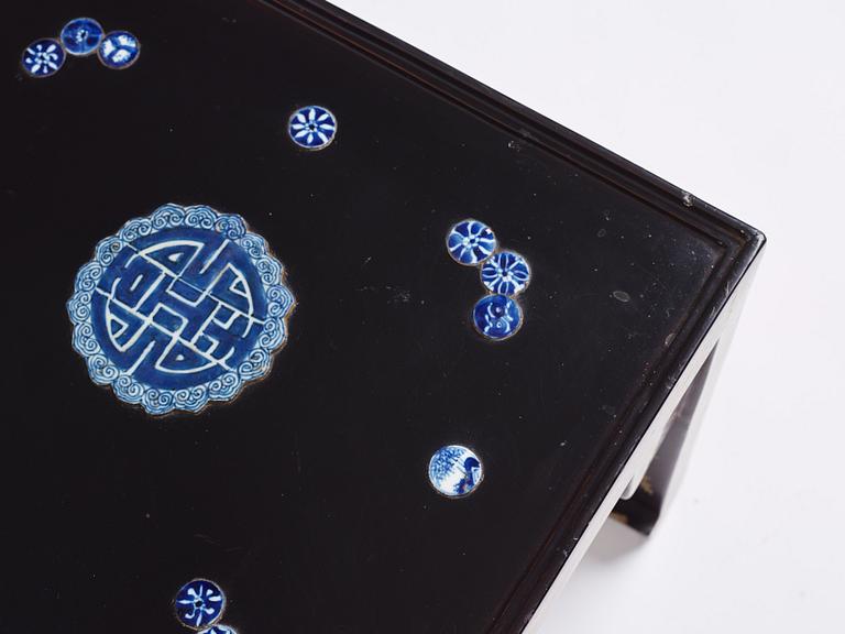 A Chinese black lacquered table with porcelain placques, presumably first half of the 20th century.