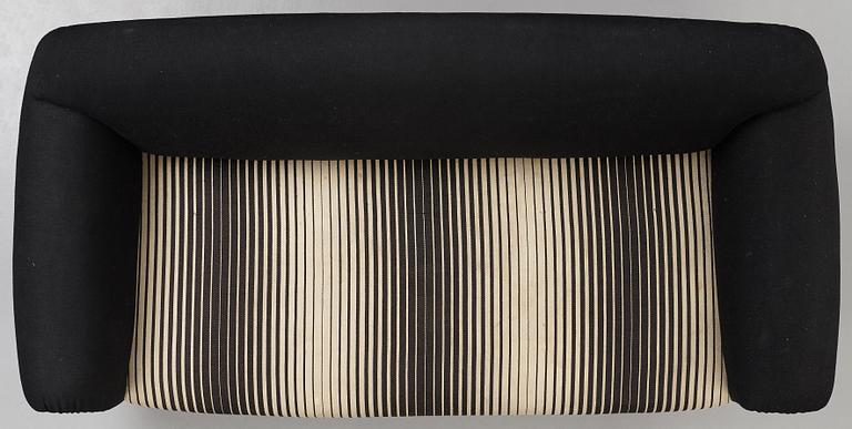 A 1940's sofa, upholstered in black and white striped fabric.