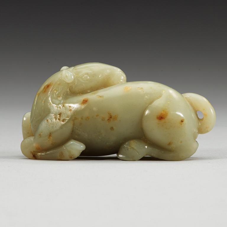 A carved nephrite figure of a reclining horse.