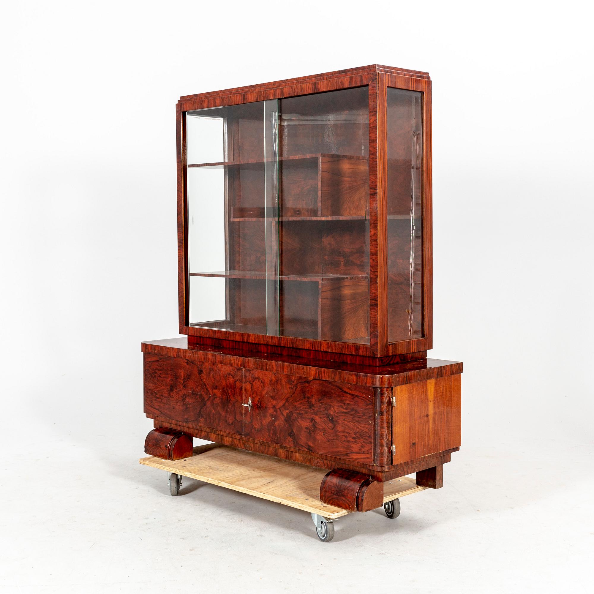 A walnut Art Deco early 1900s display cabinet.