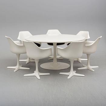 A dining table and eight chairs by Robin Day, Arkana.