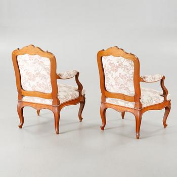 A pair of rococo style arm chairs, early 20th century.