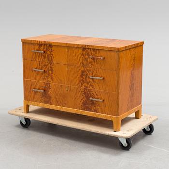 A 1930s art déco birch veneered chest of three drawers.