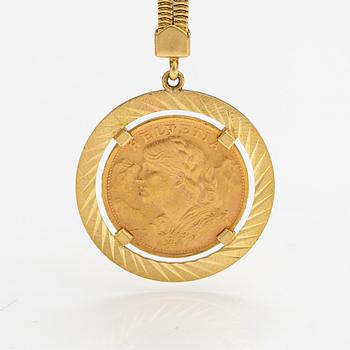 A keychain made of 18K gold with a 900 gold Helvetia 20 franc coin.