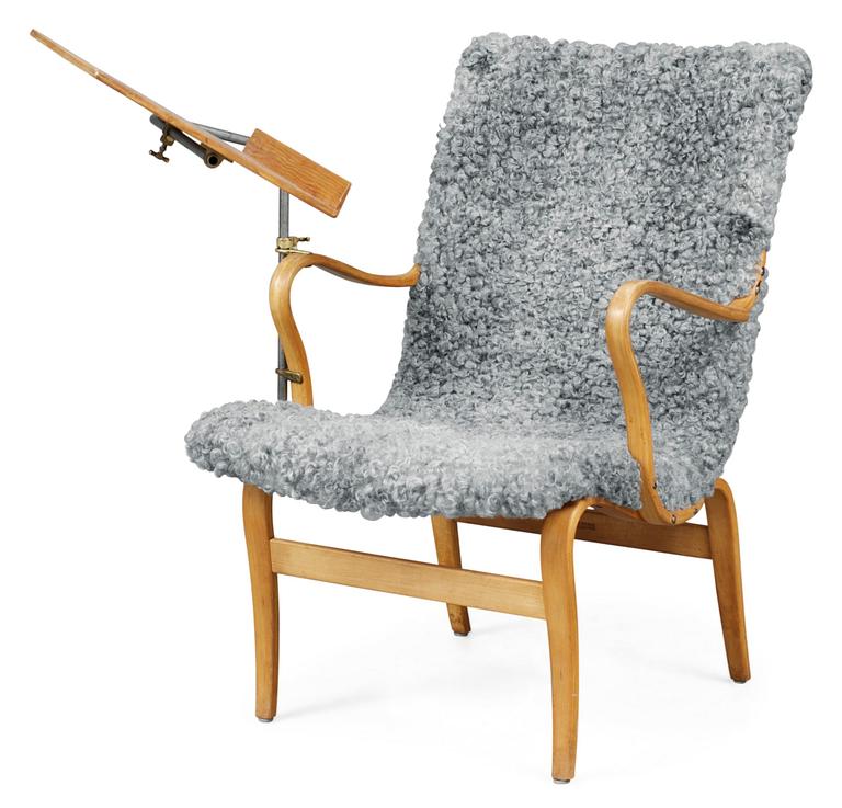 A Bruno Mathsson easy chair with a reading table, later upholstery in grey sheep skin, Firma Karl Mathsson Värnamo, probably 1940's.