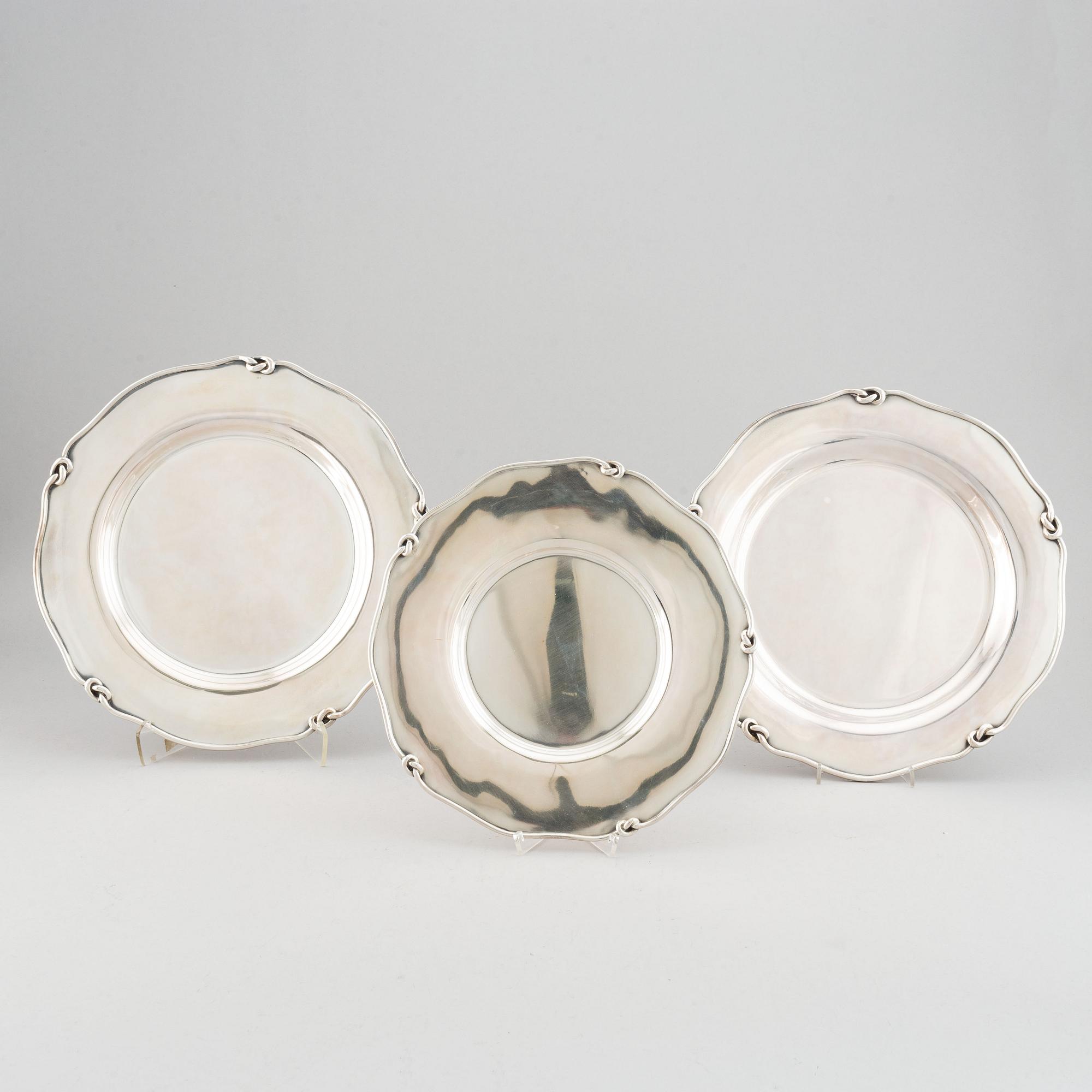Three silver serving plates, decorated with "knots", Swedish import marks.