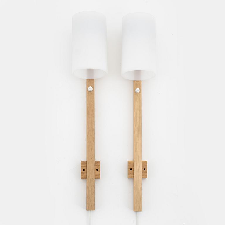 A pair of oak and acrylic wall lights, Luxus, Vittsjö.