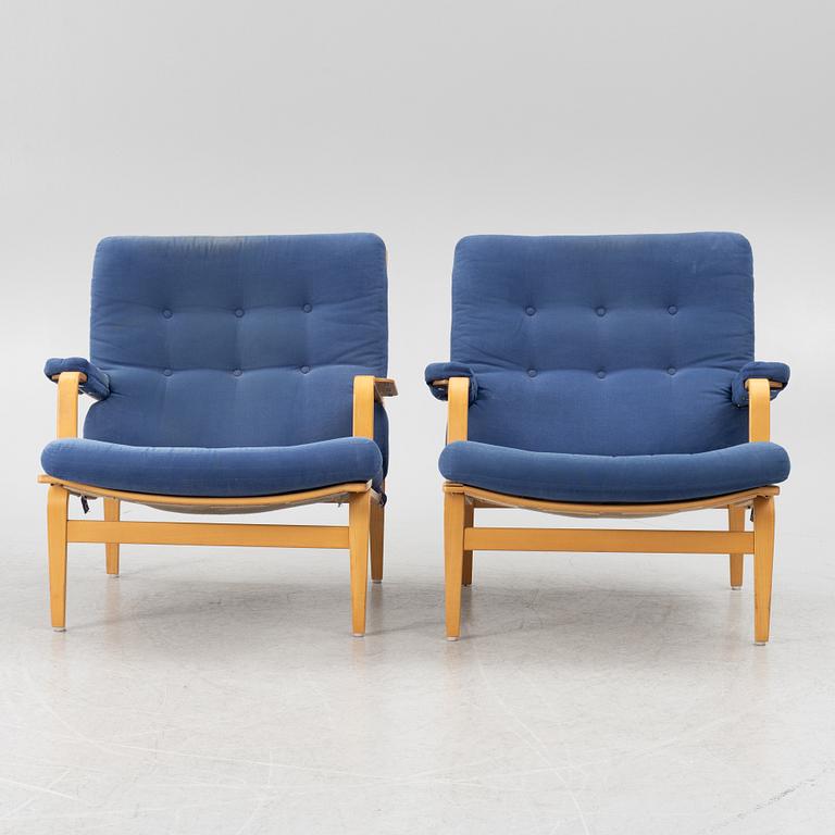 Bruno Mathsson, a pair of armchairs with ottomans, 'Ingrid', Dux, second half of the 20th century.