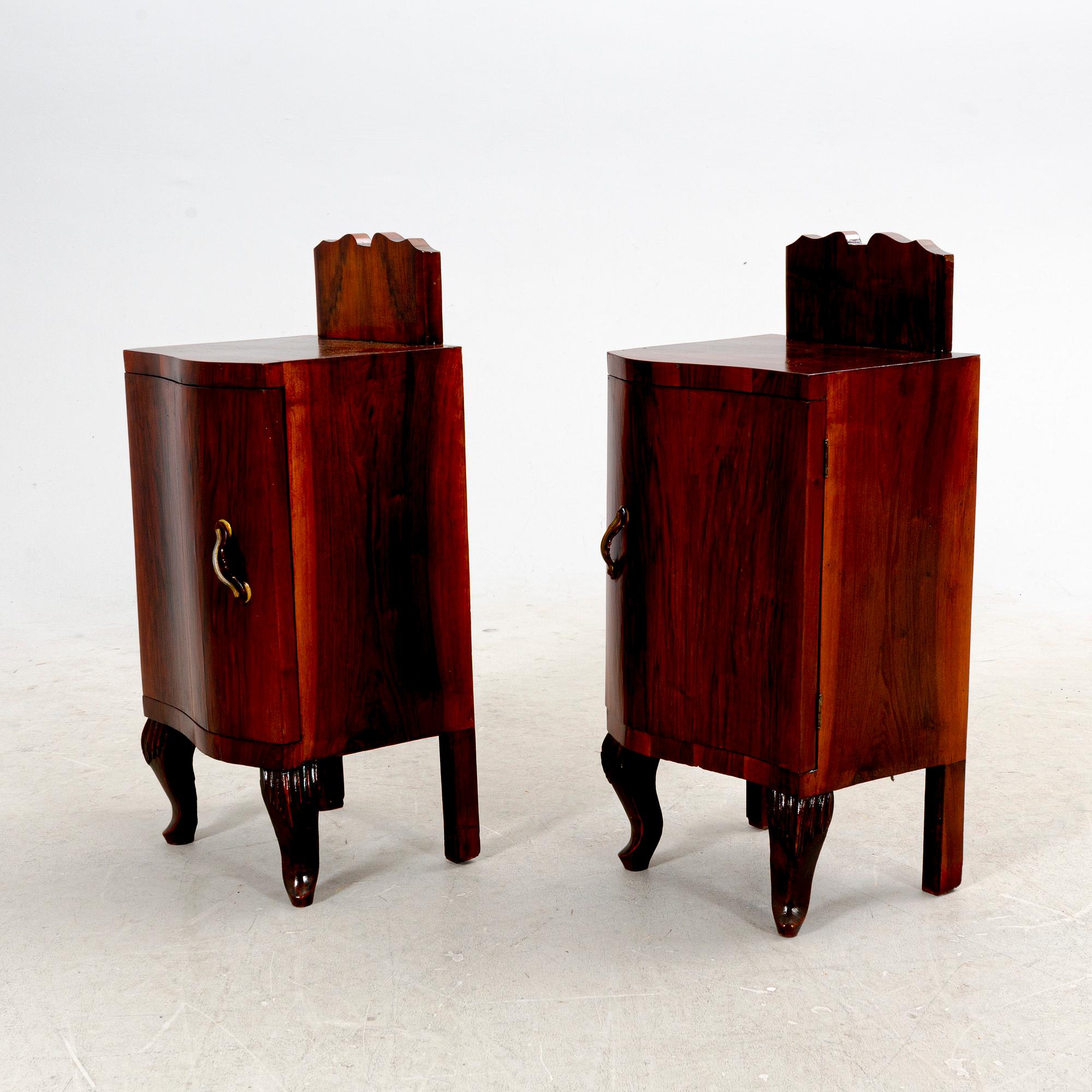 A pair of veneered walnut bedside tables from the first half ot the ...