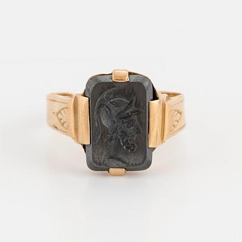 A signet ring set with carved hematite.