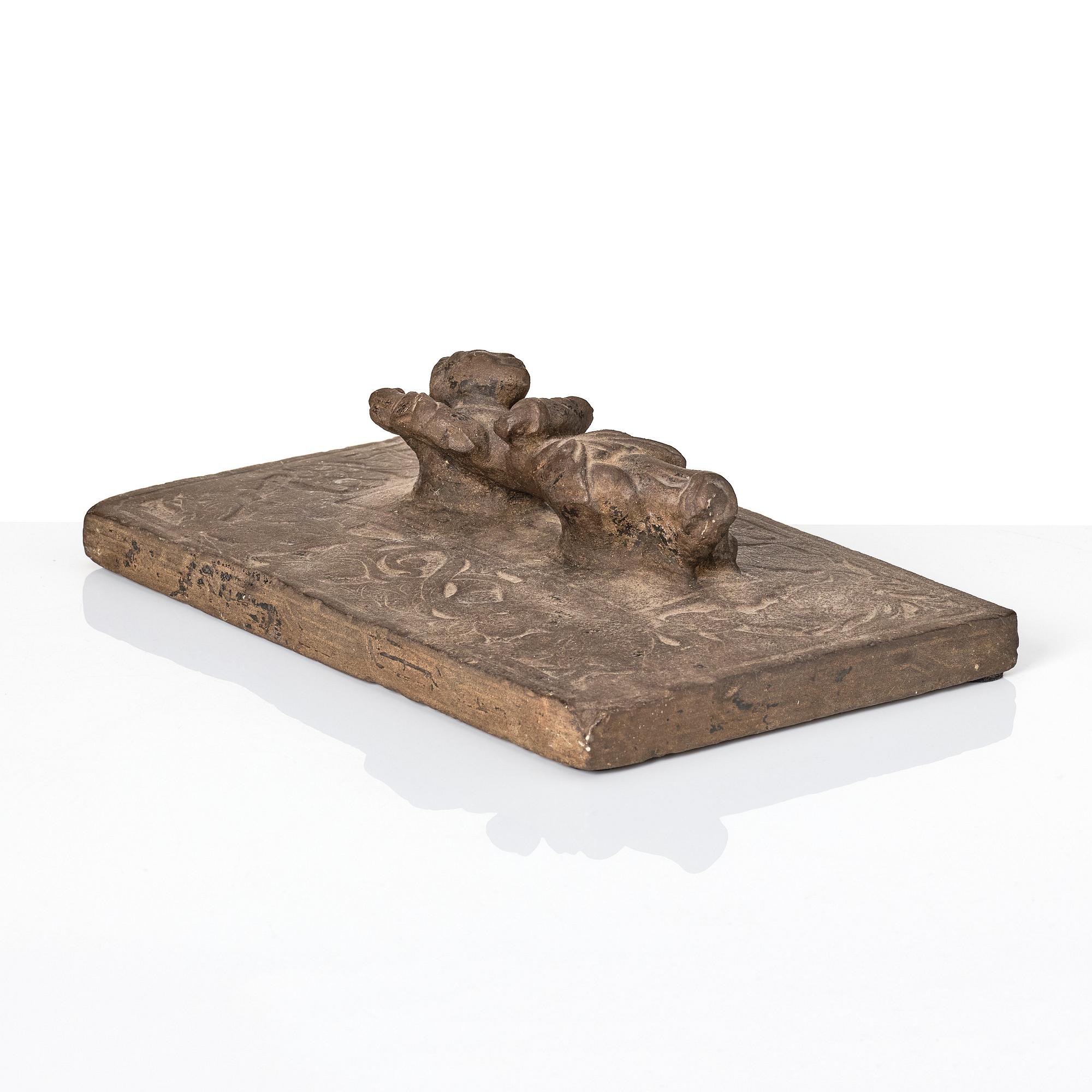 A heavy stone slate/press, presumably Ming dynasty (1368-1644).