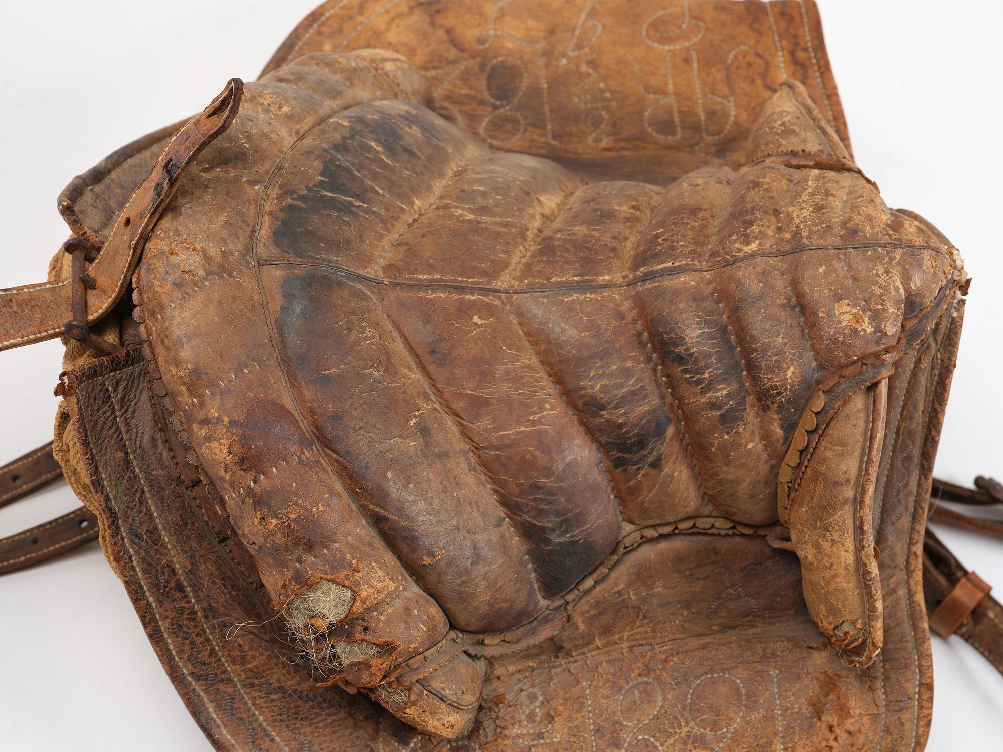 A leather saddle of Caucasian type, dated 1821.