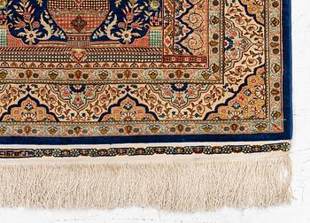 A semi-antique silk Hereke rug, West Anatolia, signed c. 107 x 72 cm.