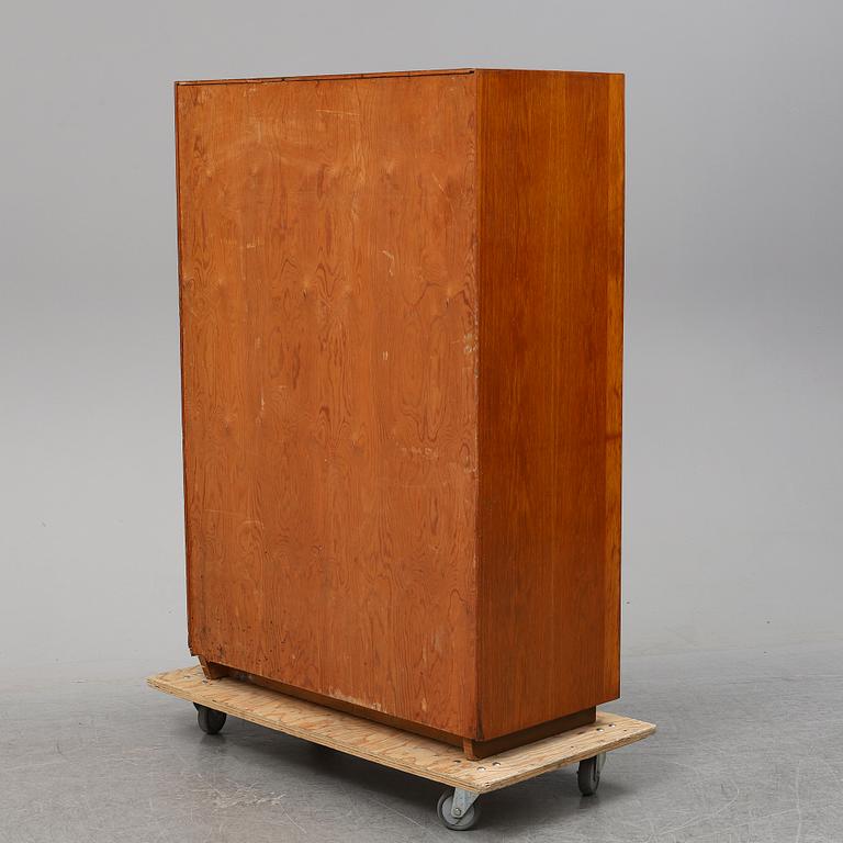 A oak cabinet from the first half of the 20th century.