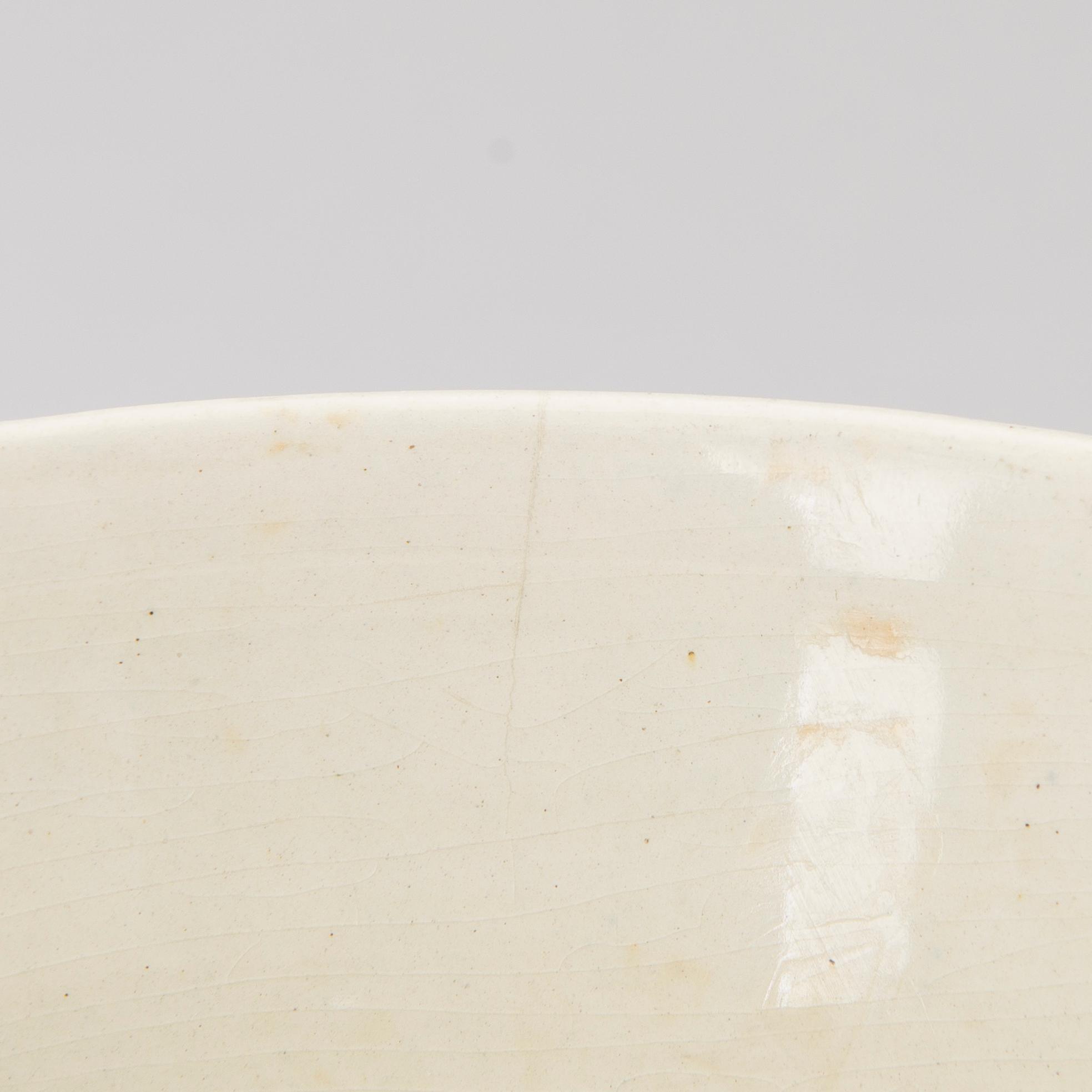 A ceramic bowl signed GT.