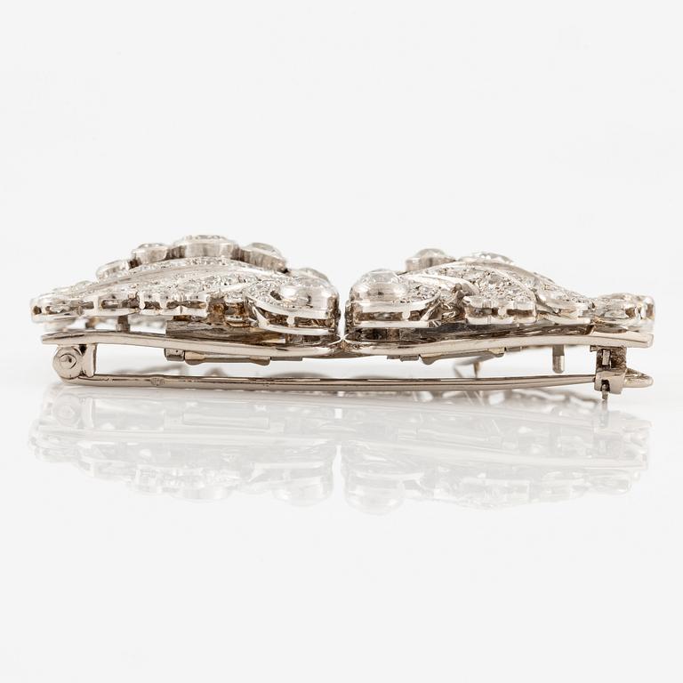 A brooch/double clip in platinum set with old- and eight cut diamonds.