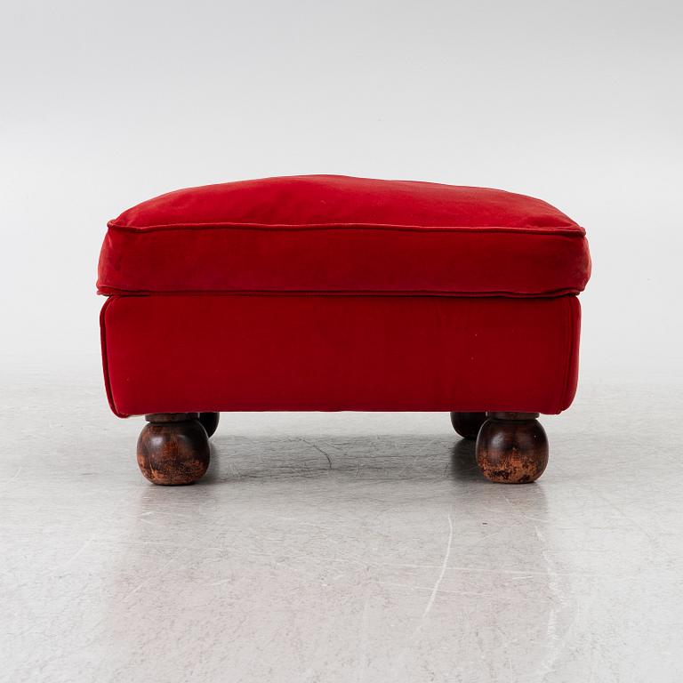 A pair of Howard-style armchairs and a footstool, late 20th century.
