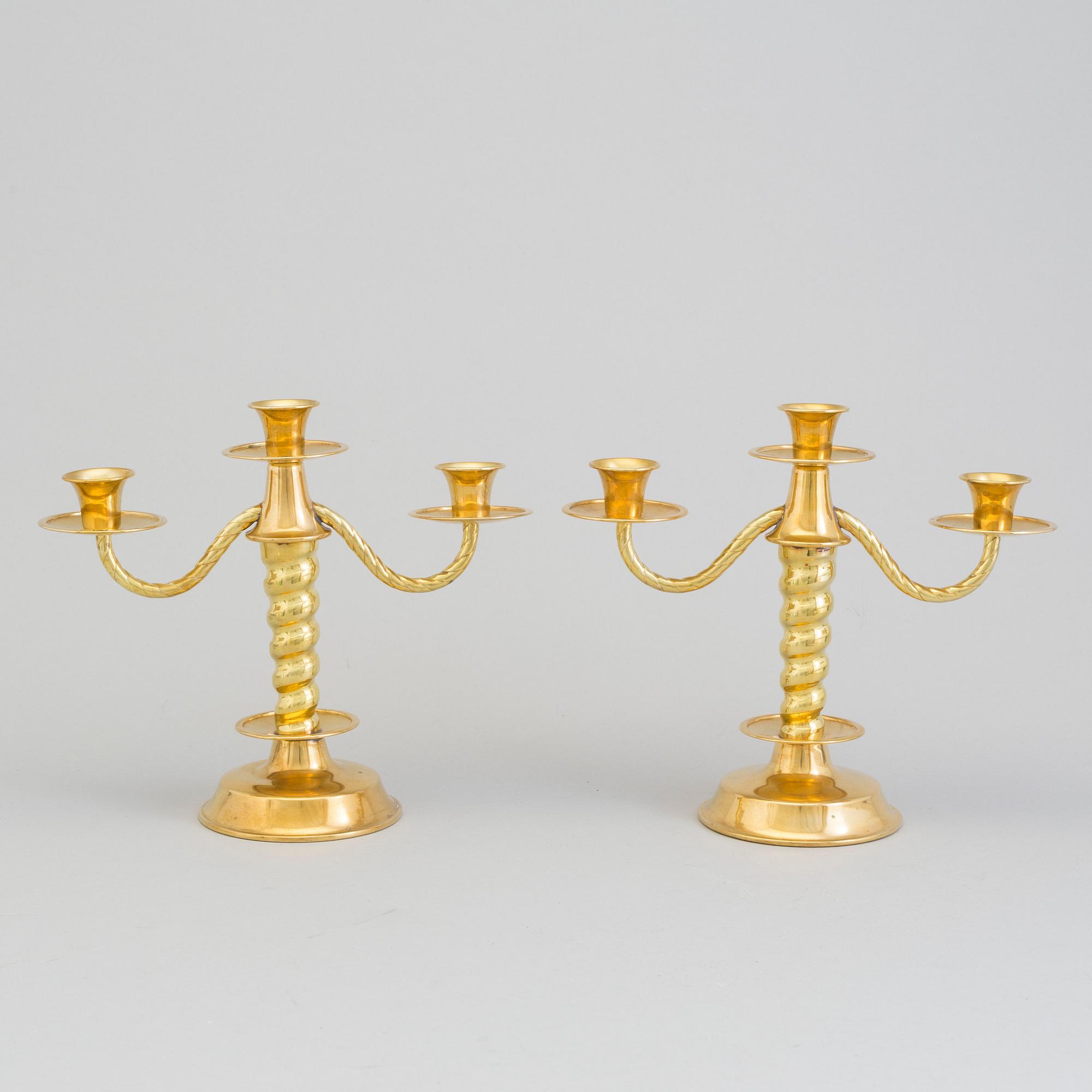 a pair of brass candelabras by Gottfrid Carlsson Eskilstuna.