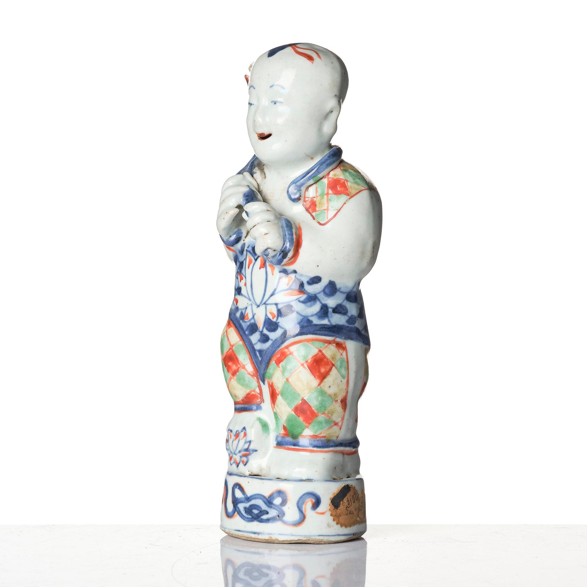 Three Chinese famille verte figures of laughing boys 'Hehe Erxian', 18th century.