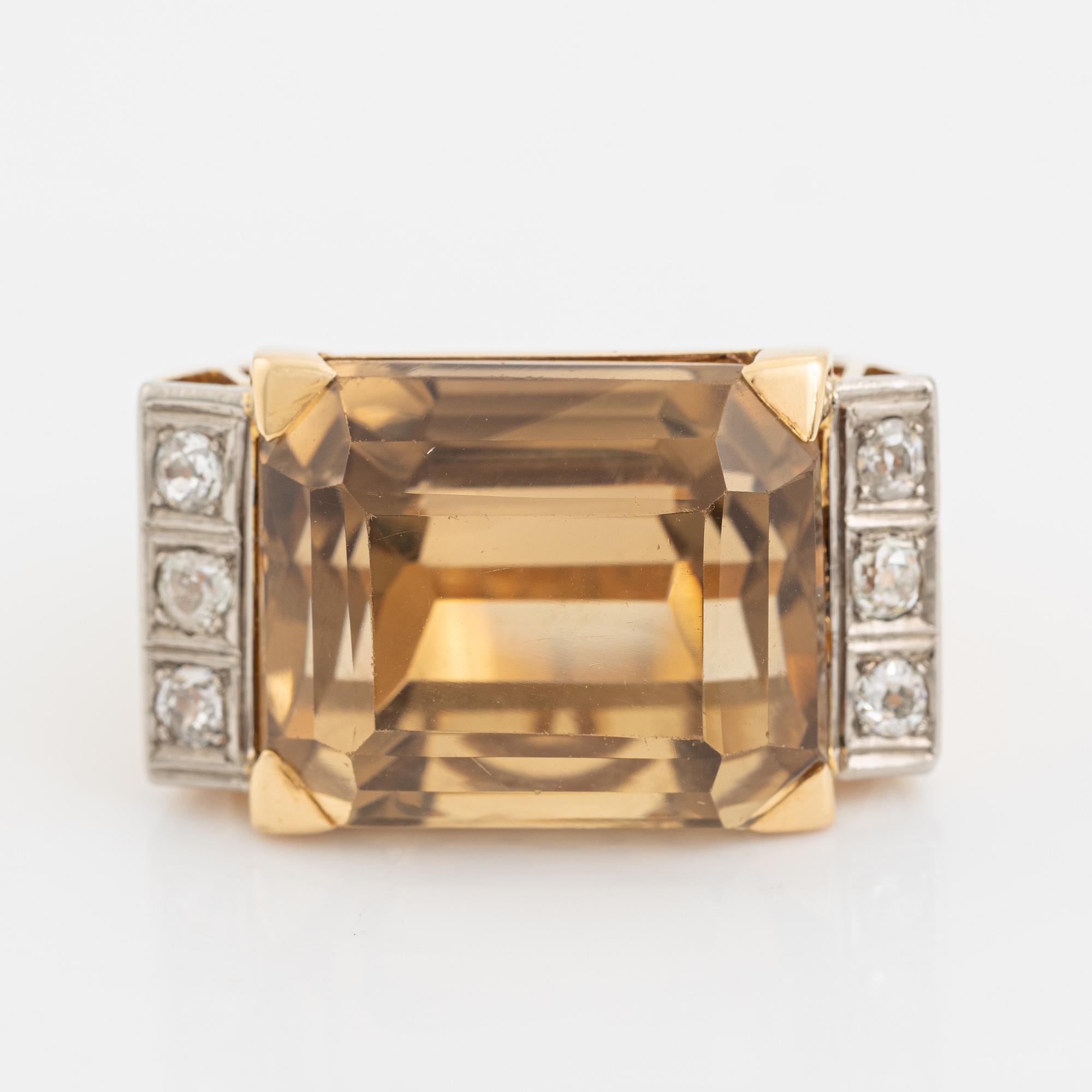 An 18K gold ring set with faceted quartz and old-cut diamons.