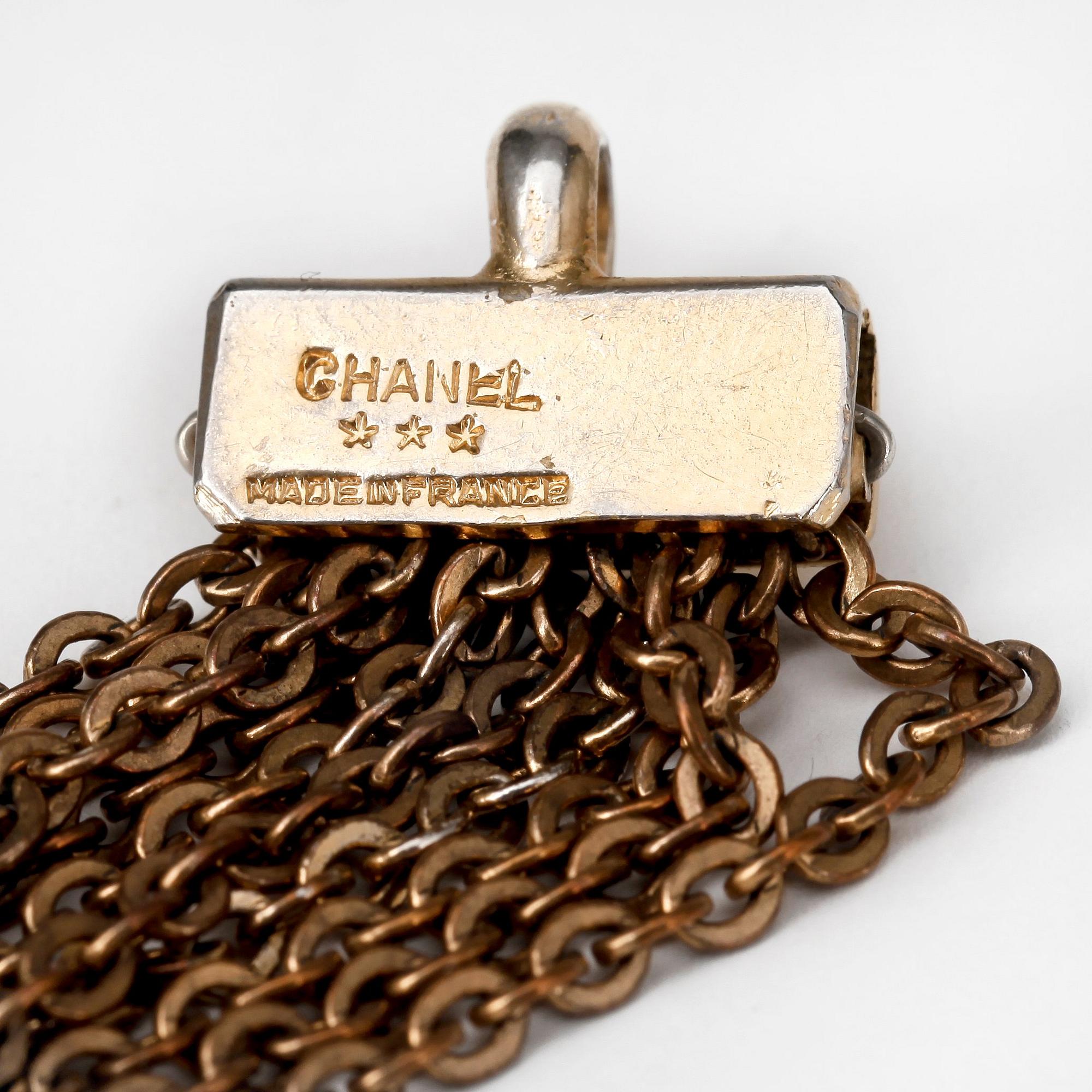 CHANEL, a gold colored metal necklace.
