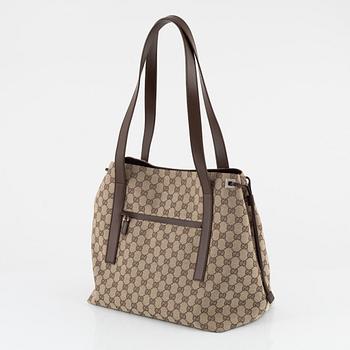 Gucci, a canvas handbag.