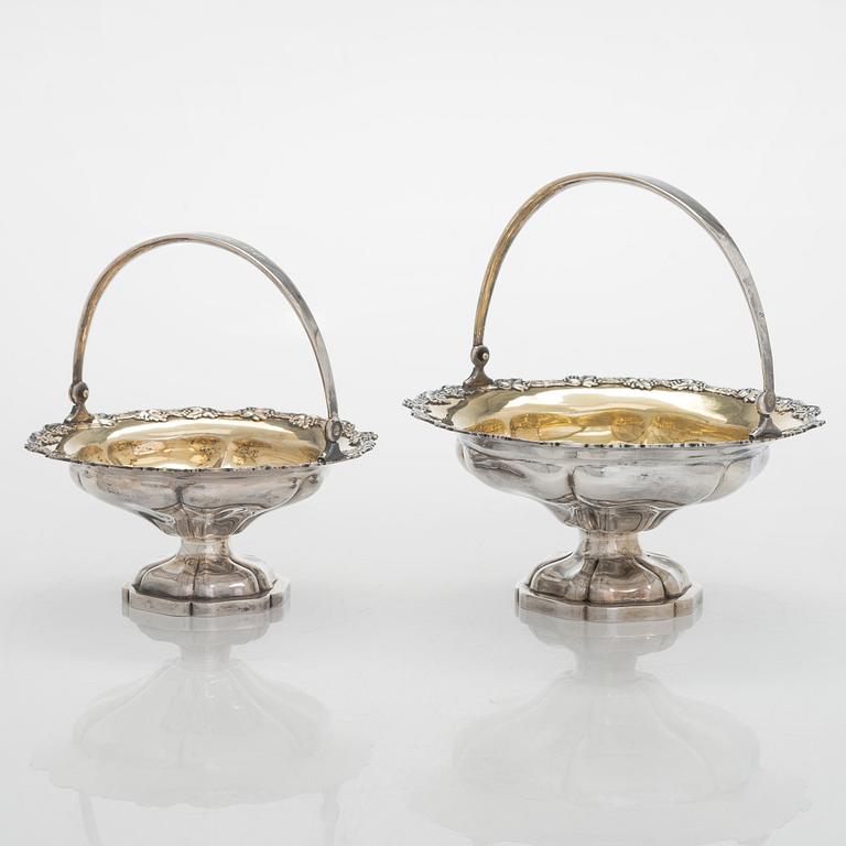 A set of two 1920s-1930s silver sweetmeat basket with sugar tong and jam spoon, Uusi Kultaseppä Oy, Helsinki, Finland.