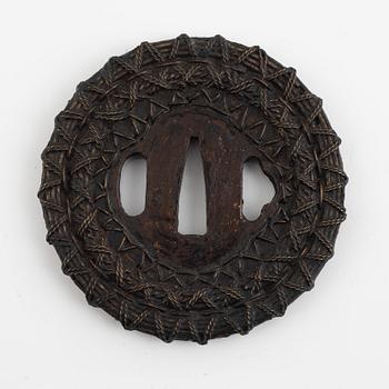 A copper-iron tsuba, Edo (1603-1868), 18th century, in a kiri box.